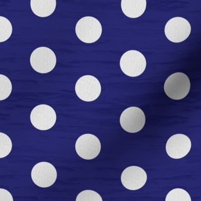 Dark blue rock wall with white linen polka dots