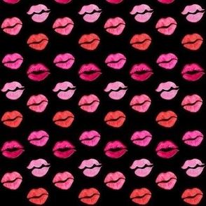 Lips with lipstick kisses in red and pink on black