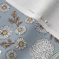 Little sketched wild flowers garden boho daffodil daisies and hydrangea flowers and leaves spring nursery white mint green blush on moody blue gray sky 