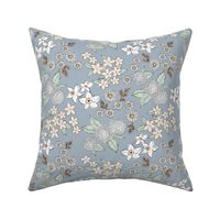 Little sketched wild flowers garden boho daffodil daisies and hydrangea flowers and leaves spring nursery white mint green blush on moody blue gray sky 