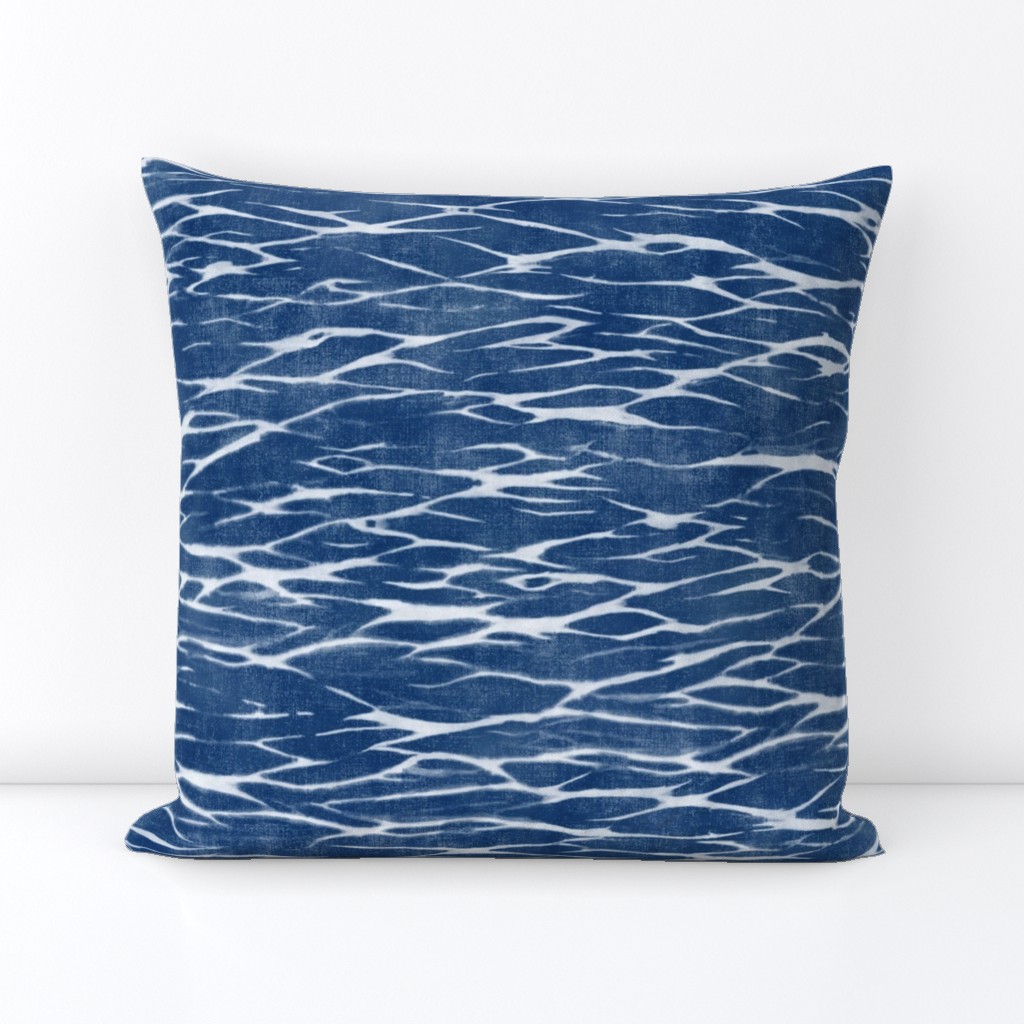 Shibori Linen in Bright Indigo (large scale) | Deep blue arashi shibori pattern, pole wrapping, rustic linen texture, boho tie dye fabric in blue and white.