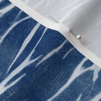 Shibori Linen in Bright Indigo (large scale) | Deep blue arashi shibori pattern, pole wrapping, rustic linen texture, boho tie dye fabric in blue and white.