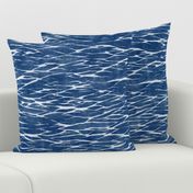 Shibori Linen in Bright Indigo (large scale) | Deep blue arashi shibori pattern, pole wrapping, rustic linen texture, boho tie dye fabric in blue and white.