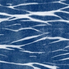 Shibori Linen in Bright Indigo (xl scale) | Deep blue arashi shibori pattern, pole wrapping, rustic linen texture, boho tie dye fabric in blue and white.
