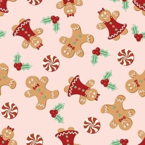 Medium Christmas Gingerbread Men and Women surrounded by Holly and Round Peppermint Candy with Pale Pink Background