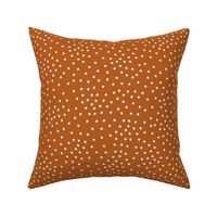 Scattered White Dots on Solid Burnt Orange Background