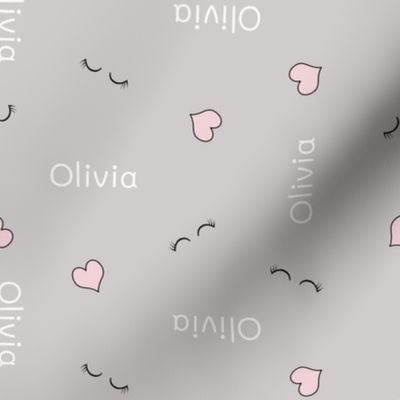 OLIVIA name with small hearts and eyelashes on soft gray 