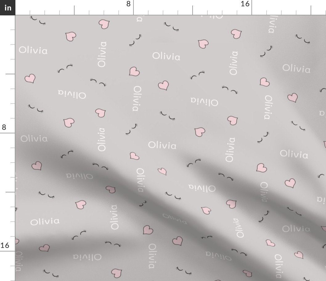 OLIVIA name with small hearts and eyelashes on soft gray 