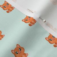 small scale ginger cat on light turquoise background