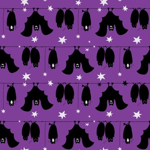 Hanging bats on purple background pattern.