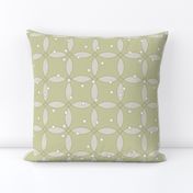 overlapping rings in beige with white dots on light olive green