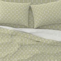 overlapping rings in beige with white dots on light olive green