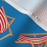 Red and Blue Striped Deck Chairs on Cyan Blue Background