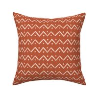 Hand drawn mudcloth design with zigzag lines and dots in rust, medium
