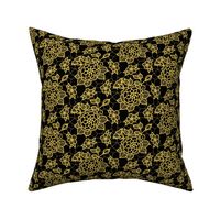 Gold lace flower on black