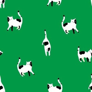 Stylish minimalistic pattern with black and white cats on green background . Cute modern Scandinavian print 3
