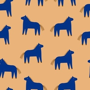 Cute and stylish seamless pattern with  blue horses on peach background. Funny childish vector cartoon background 