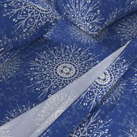 White Mandalas and snow on a denim blue background - large scale