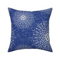 White Mandalas and snow on a denim blue background - large scale