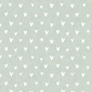 White hand drawn hearts on pastel green mint 
