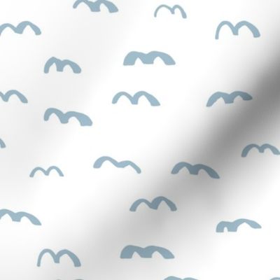 Flock of birds hovering above fly on minimalist sky design in baby blue on white