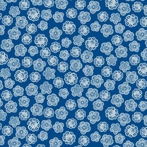Small lace flowers white on blue