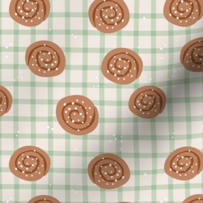 Snack time - cinnamon bun Swedish bakery picnic lunch with sugar sprinkles on plaid mist green sand