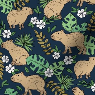 Wild animals - freehand sketch capybara jungle friends with monstera leaves and tropical hibiscus flowers beige sand sage olive green mustard  on navy blue 