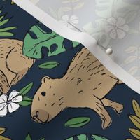 Wild animals - freehand sketch capybara jungle friends with monstera leaves and tropical hibiscus flowers beige sand sage olive green mustard  on navy blue 