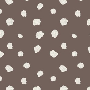 Cute little cotton buds on brown background