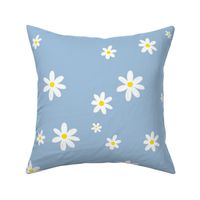 Daisies blooming on light blue background. Spring flowers seamless pattern