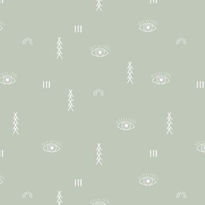 Moroccan kelim design with eyes and sunshine and berber symbols white on sage green