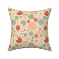 Blue, green, and orange circles on a peach background 
