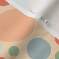 Blue, green, and orange circles on a peach background 