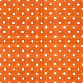 White handdrawn spots on orange slub plaid