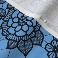 Black lace flower on blue 