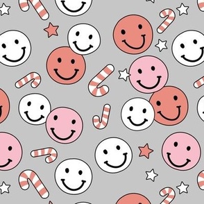 Happy holidays smiley christmas with smileys candy canes and stars retro style seasonal design vintage red pink on gray girls