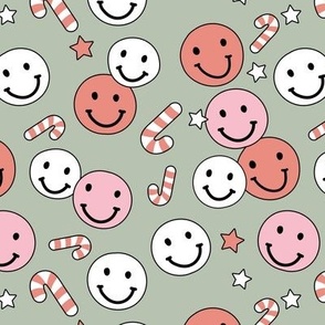 Happy holidays smiley christmas with smileys candy canes and stars retro style seasonal design vintage red white pink on sage green  