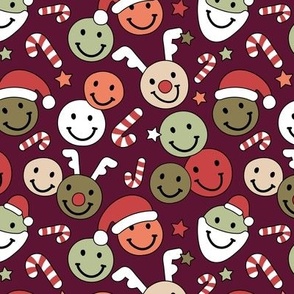 Happy holidays smiley christmas with smileys stars happy santa claus candy cane and reindeer vintage orange red green on burgundy