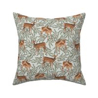  Cute deer with green tree branches around. Woodland deer