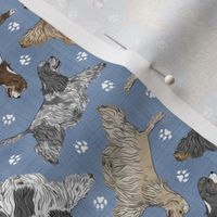 Tiny Trotting tailed Cocker Spaniels and paw prints - faux denim