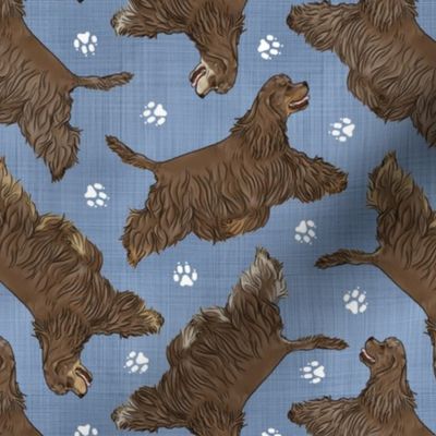 Trotting chocolate tailed Cocker Spaniels and paw prints - faux denim