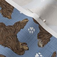 Trotting chocolate tailed Cocker Spaniels and paw prints - faux denim