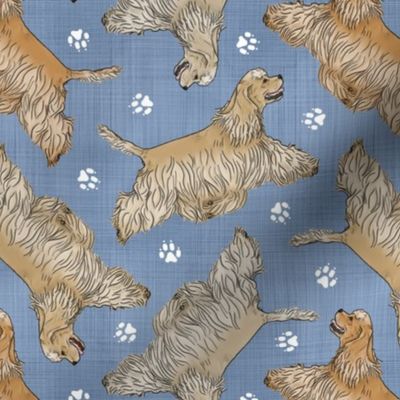 Trotting buff tailed Cocker Spaniels and paw prints - faux denim