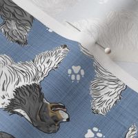 Trotting parti tailed Cocker Spaniels and paw prints - faux denim