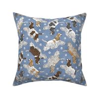 Trotting parti tailed Cocker Spaniels and paw prints - faux denim