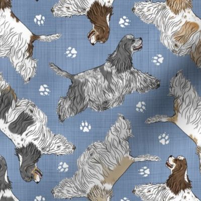 Trotting parti tailed Cocker Spaniels and paw prints - faux denim