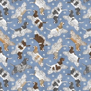 Trotting parti tailed Cocker Spaniels and paw prints - faux denim
