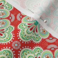 Colorful Swiss folk style floral medallions with decorative paisley peacocks on bright red 