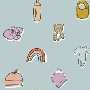 Cute Newborn Baby Nursery Items on Blue - Booties, Rainbow, Bib, Blanket, Bottle, Teddy Bear